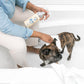 A lady wiping her pet dog after bathing it with Nellie's Fresh Dog Shampoo 